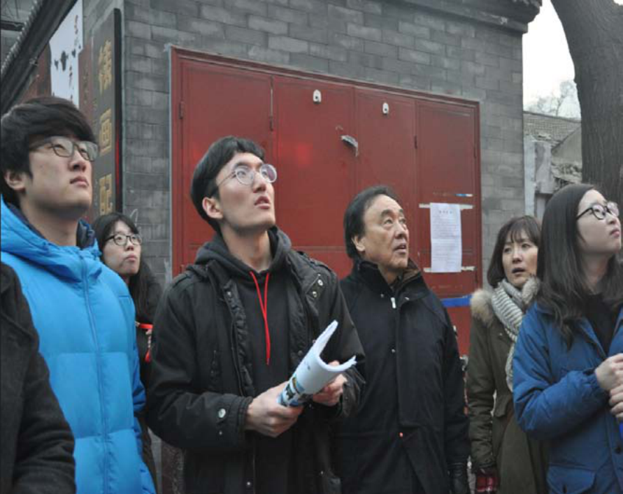 The study room participants looking up at the signs of bookstores on Window Street.
