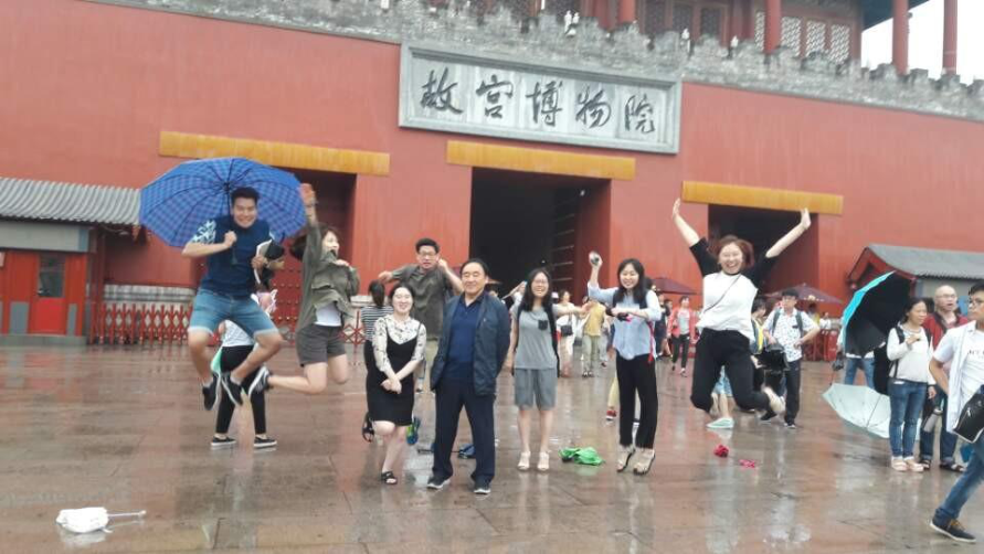 Students of the 7th cohort of Sarangbang energetically jump as they leave the Forbidden City.